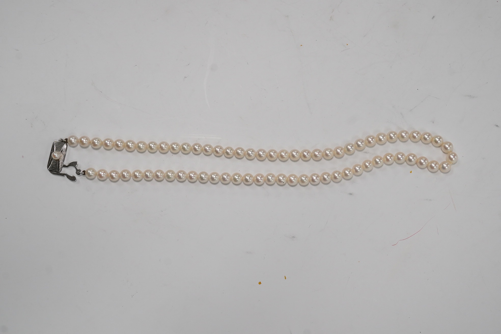 A Mikimoto single strand cultured pearl necklace, 36cm, with Mikimoto pouch. Condition - fair to good